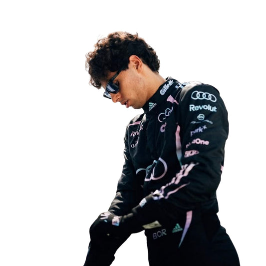Gabriel Bortoleto wearing a black racing suit with Audi and Revolut logos on a white background close view
