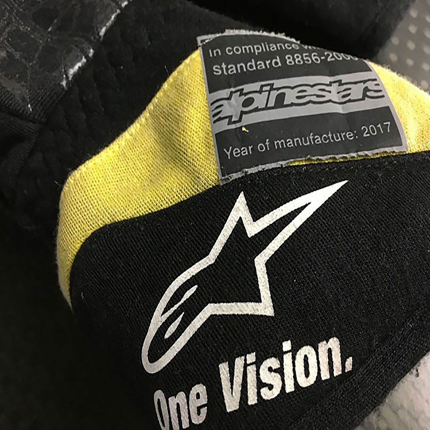 Black Carlos Sainz 2017 Renault F1 Replica Race Gloves laid flat, front view, showing the full racing design and replica stitching