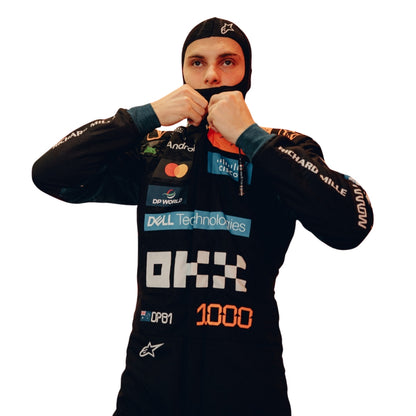 Oscar Piastri wearing a F1 racing suit McLaren Monaco GP with various sponsor logos on a white background Close View