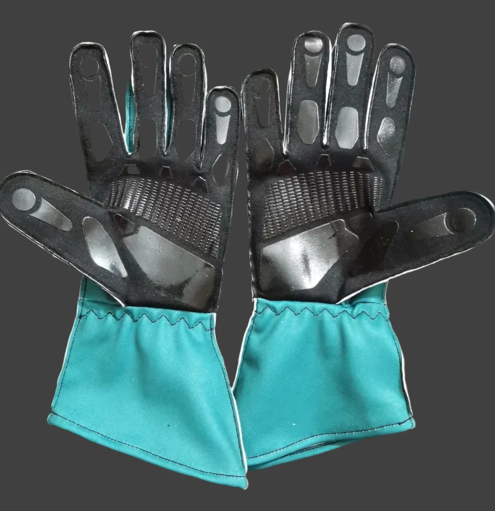 Green Aston Martin Race Gloves F1 in close-up detail, showing the palm grip pattern used in GP racing conditions