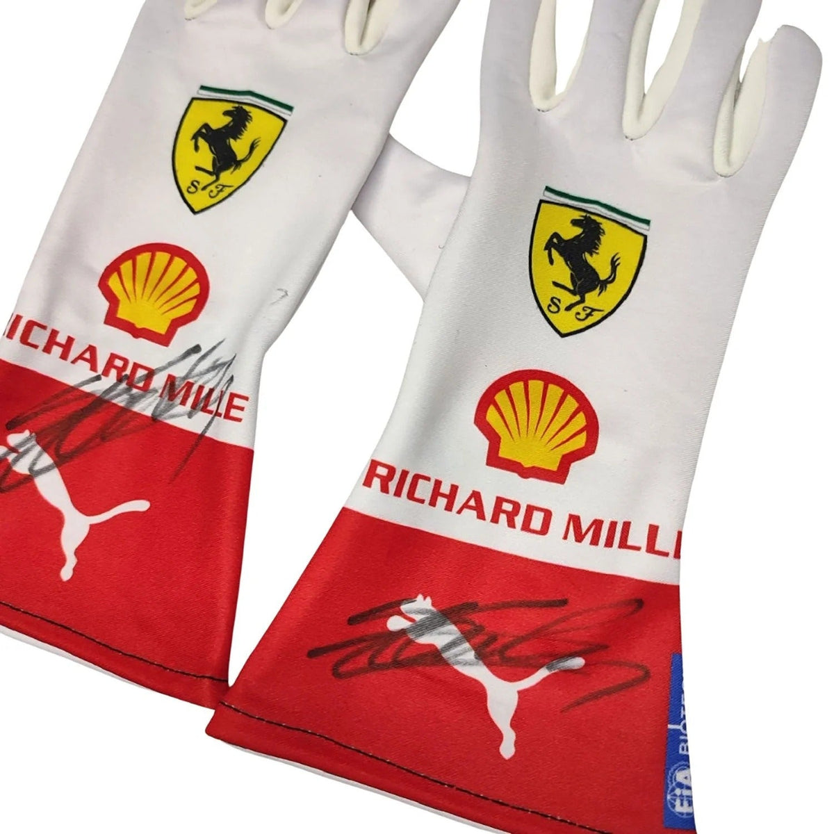Pair of white and red Charles Leclerc 2023 Monaco GP Race Gloves F1 Ferrari with Ferrari, Shell, and Richard Mille logos close up view