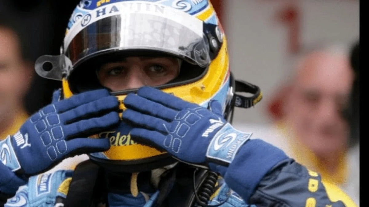Fernando Alonso wearing a racing helmet and Fernando Alonso 2006 Race Gloves F1 Renault with a blurred background