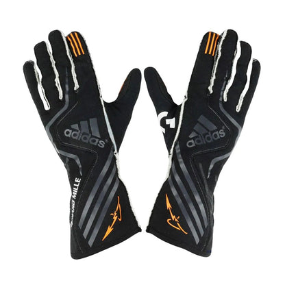 A pair of black Adidas Fernando Alonso 2017 Race Gloves Replica F1 McLaren with gray stripes, white trim, and orange accents, displayed back view