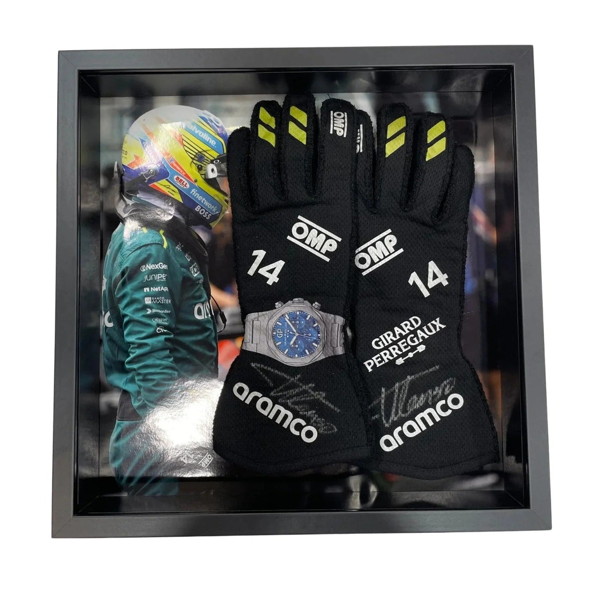 Pair of black Fernando Alonso 2024 Race Gloves F1 Aston Martin with branding in a display case, featuring a helmet and watch.