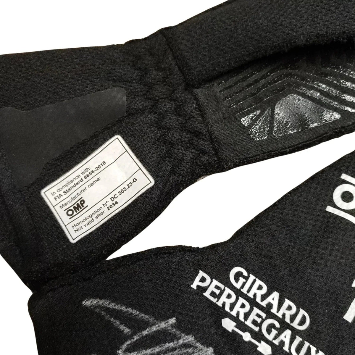 Close-up of a black Fernando Alonso 2024 Race Gloves F1 Aston Martin with Girard-Perregaux branding and OMP label.