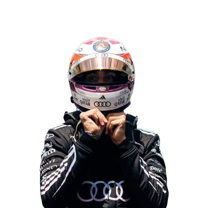 Gabriel Bortoleto wearing a black racing suit with Audi and Revolut logos on a white background close view