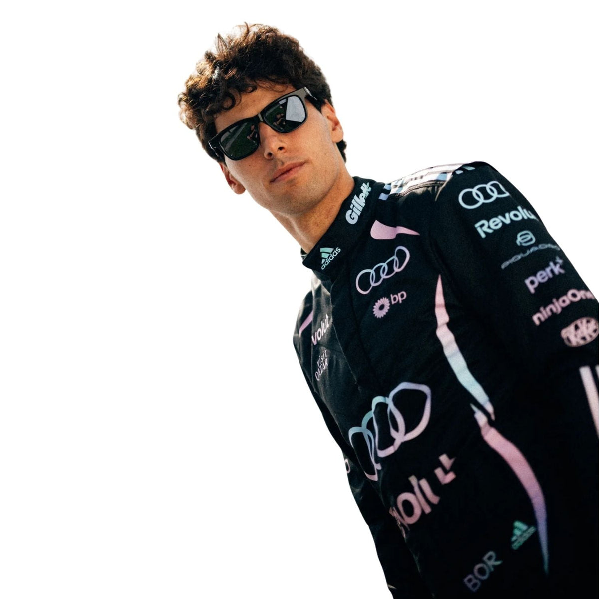 Gabriel Bortoleto wearing a black racing suit with Audi and Revolut logos on a white background close view