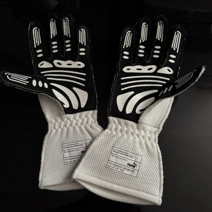 Pair of black and white George Russell 2024 Qatar GP Race Gloves F1 Mercedes with quilted white cuffs on a dark background