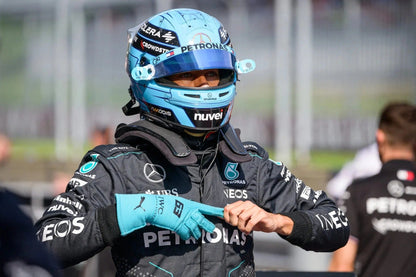 George Russell wearing a Formula 1 racing suit George Russell 2024 Race Gloves F1 Mercedes and helmet with visible branding.