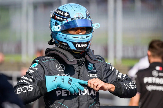 George Russell wearing a Formula 1 racing suit George Russell 2024 Race Gloves F1 Mercedes and helmet with visible branding.