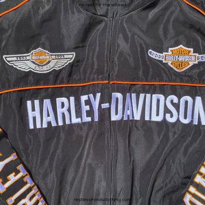 Harley Davidson heritage motorsport jacket, with printed sponsor-style graphics across the sleeves. Retro race day attire for car meets, circuits and cosplay nights.