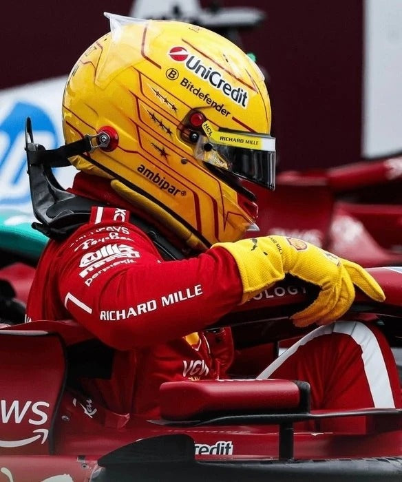 Lewis Hamilton in a red racing suit and yellow helmet with 2025 Yellow Replica Race Gloves F1 Ferrari sitting in a Formula 1 car.