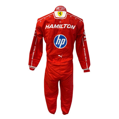 A red Scuderia Ferrari racing suit with sponsor logos including HP, Puma, and Scuderia Ferrari, featuring the name HAMILTON on the back, shown on a white background.