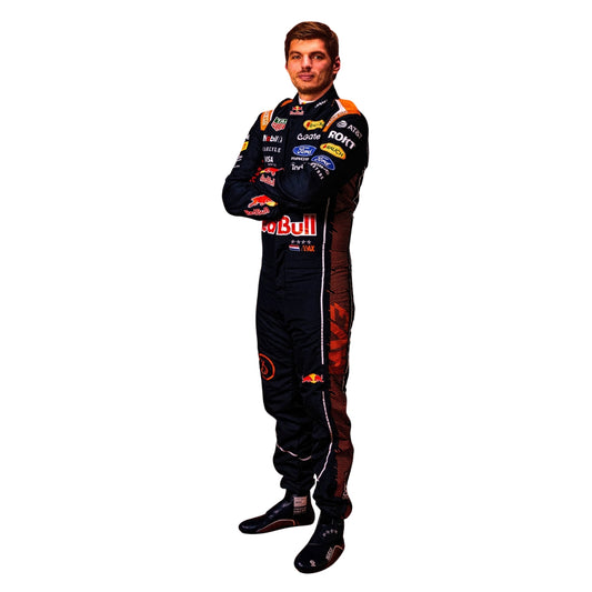 A full-body cutout of Red Bull Racing driver Max Verstappen wearing a black racing suit with multiple sponsor logos and red accents, standing with arms crossed against a plain white background.