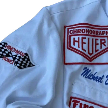 Close-up of a white Michael Delaney 1971 F1 The LeMans Movie Race Costume PorscheGulf (Steve McQueen) with embroidered logos and text.