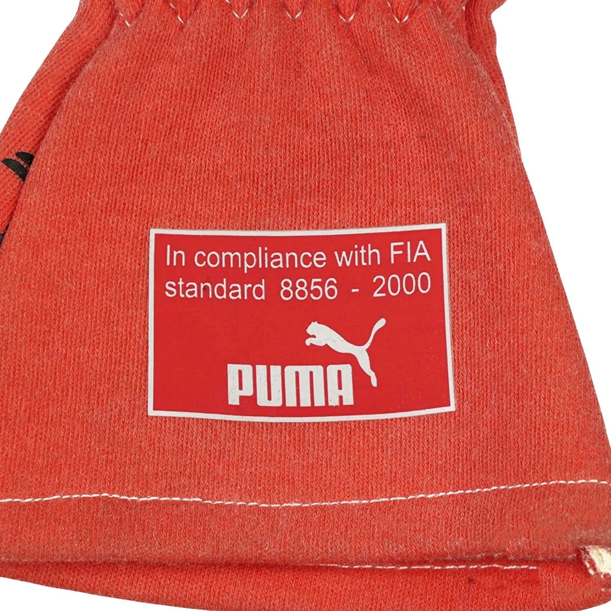 Red Michael Schumacher 2012 Race Gloves F1 Mercedes with compliance label closeup view