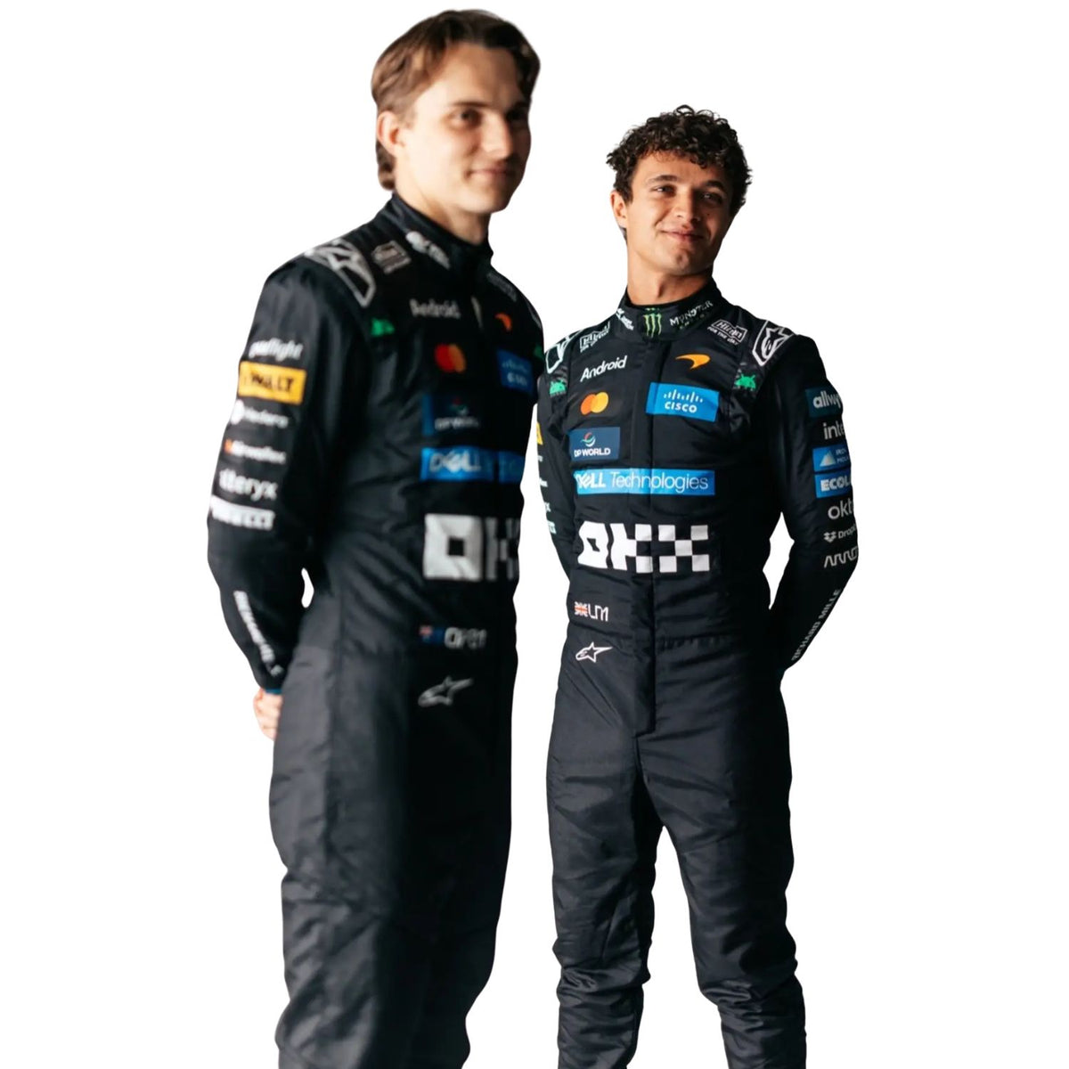 Two men standing side by side in matching black racing suits with multiple sponsor logos, photographed against a plain white studio background.